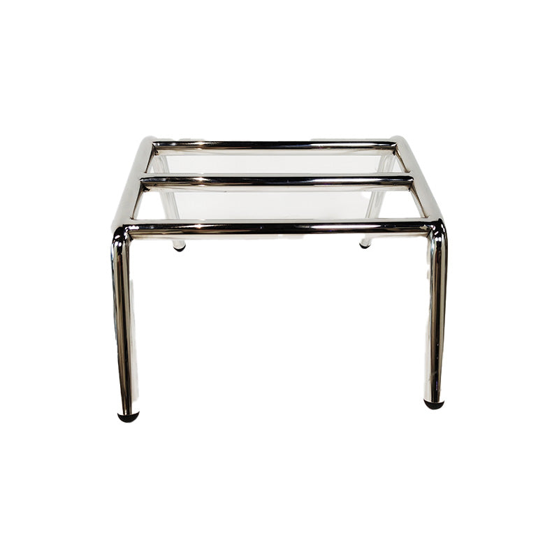 Front view of stainless steel 3 bar barber footrest floor mounted