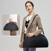 Woman carrying the professional Arch LED nail lamp in its custom black portable carry bag