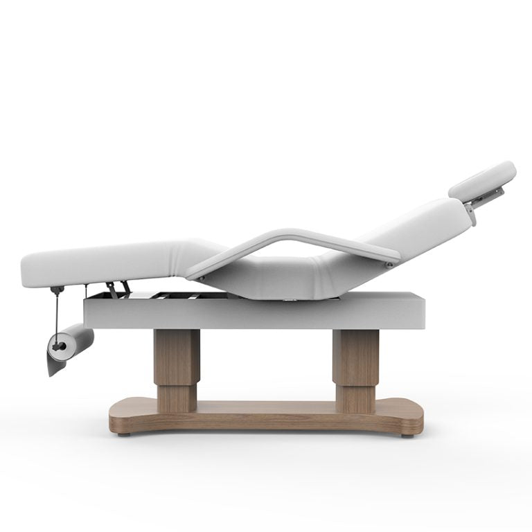 White vinyl beauty bed showing adjustable leg lift section and timber pillars