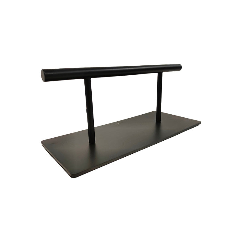 angled view of black professional salon footrest floor mounted