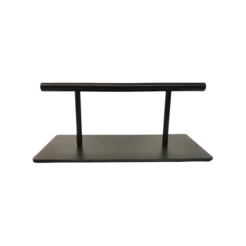 Black floor mounted salon and barber footrest for professional use