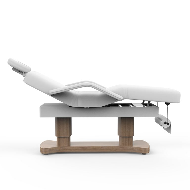 Full electric salon bed showing tilted adjustment capability for clinical treatments
