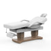 Professional electric beauty treatment table with reclining backrest and armrests in white