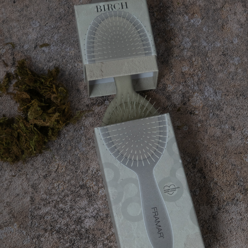 Unboxing the Framar Neutrals Sage Birch detangle brush showing biodegradable materials