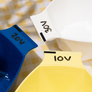 Close up of Framar Write N' Wipe bowls showing 10V, 20V, and 30V developer labels written on the tabs