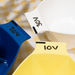 Close up of Framar Write N' Wipe bowls showing 10V, 20V, and 30V developer labels written on the tabs