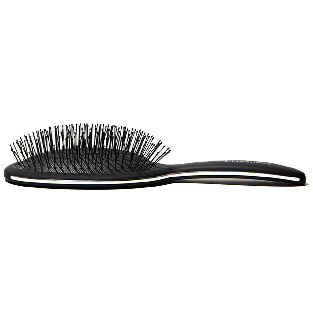 Side profile of the black Framar brush showing the flexible detangling bristles
