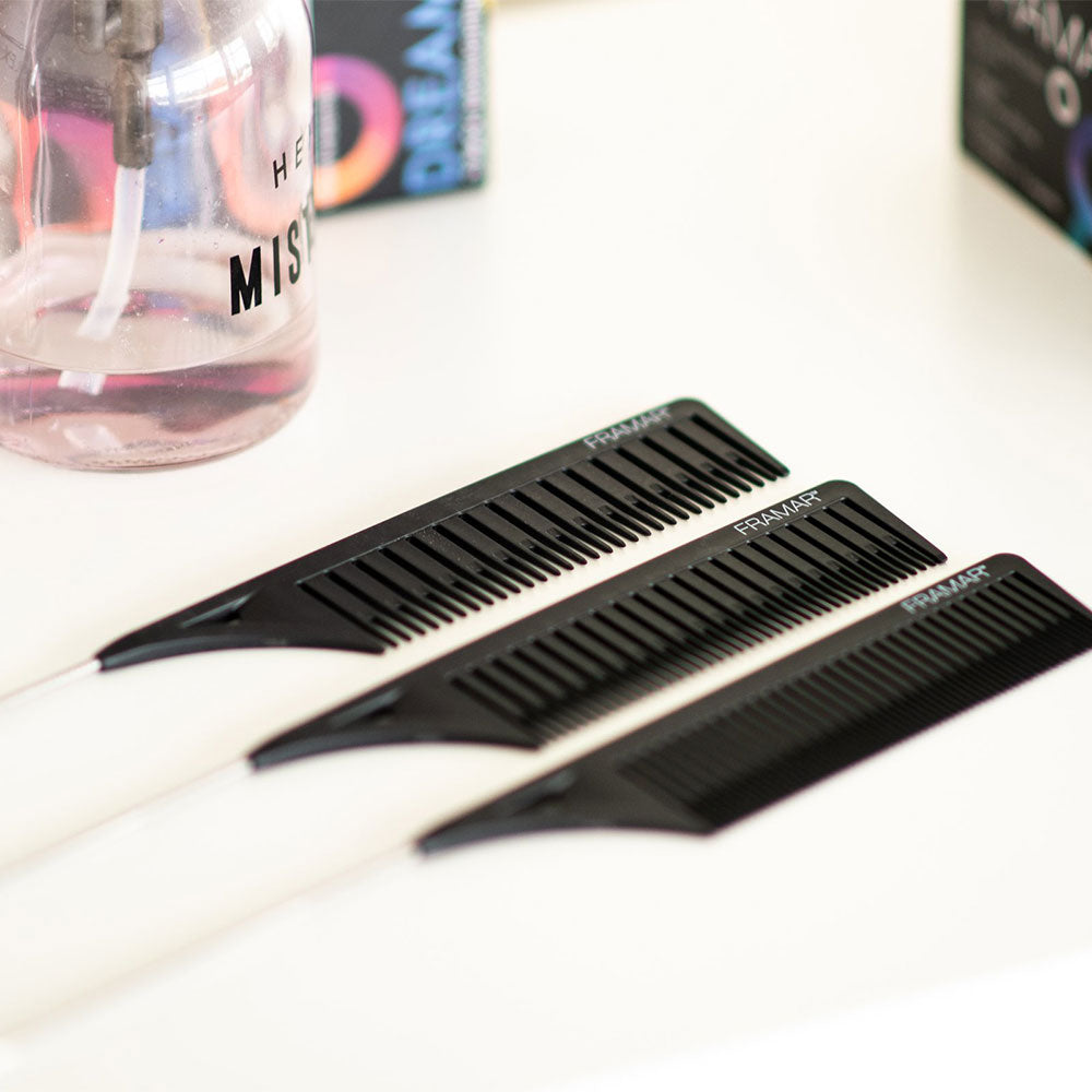 Set of three black Framar Dream Weaver professional highlighting combs on a salon station