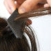 Professional stylist using a Framar Dream Weaver comb to separate hair for highlights
