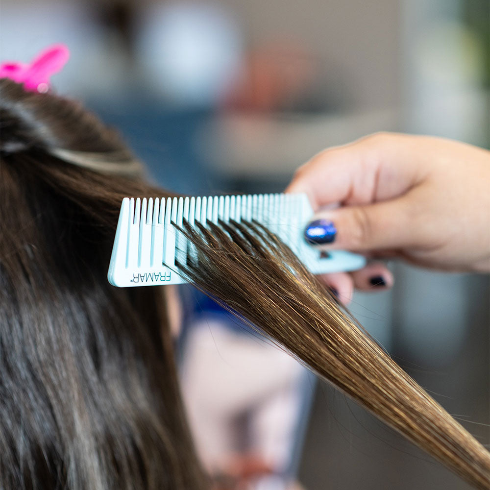 Using the pastel blue Framar Dream Weaver comb to create even hair sections for foils
