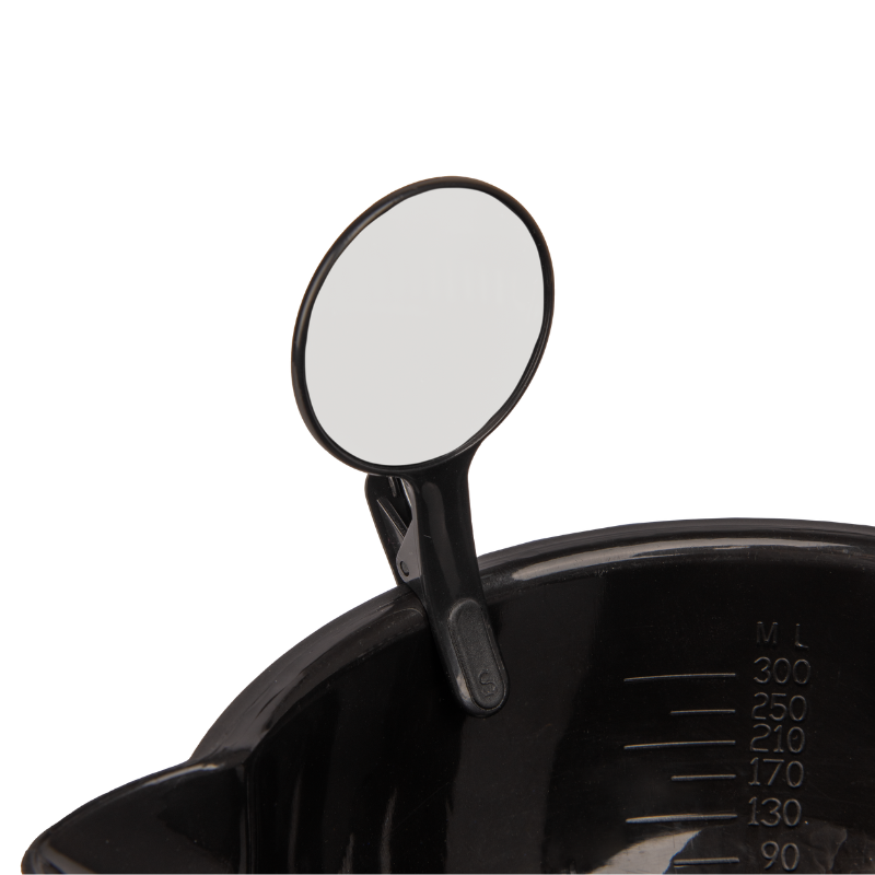 Close up of a black Framar Formula Friend dry erase clip attached to the rim of a professional hair colour mixing bowl