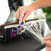 Professional stylist using the built-in slider cutter on the Framar Funked Up Film box for precise sectioning