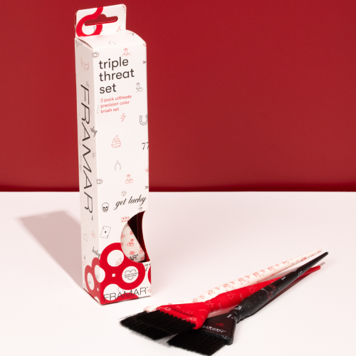 Close up of red and black Framar Get Lucky brushes showing the AccuSoft tapered bristles