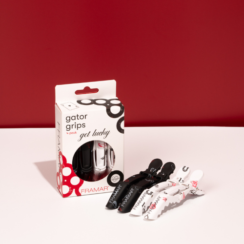 Set of four Framar Get Lucky Gator Grip clips beside their retail box for professional hair sectioning