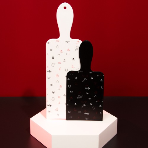 Close up of the Framar Get Lucky black and white hair colour paddles on a display stand