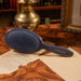 Framar Midnight hairbrush displayed on a desk, showcasing its premium design for high-end beauty clinics