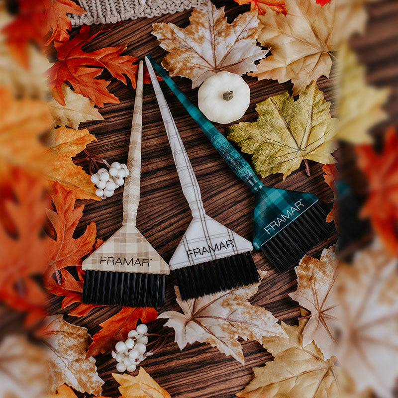 Three Framar Plaid Hair Day extra-wide colour brushes in tan, white, and teal plaid patterns