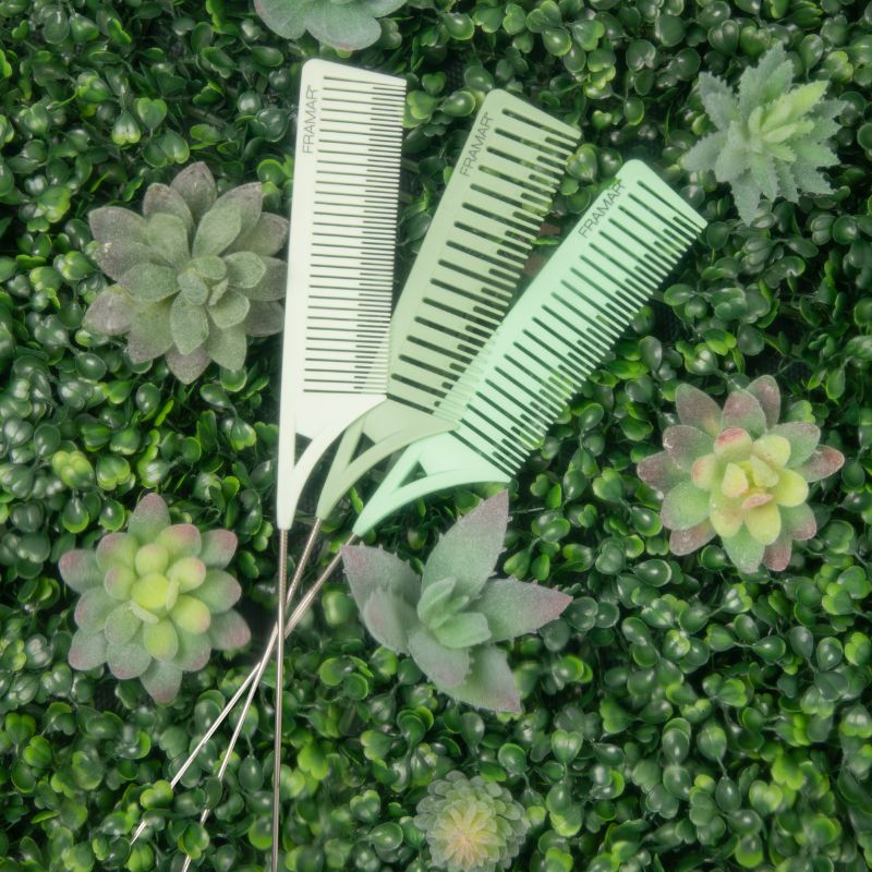 Three professional Framar highlighting combs displayed on a green textured background for salon decor inspiration