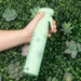 Hand holding the Framar Plant Mom Myst Assist spray bottle against a greenery background to show ergonomic grip