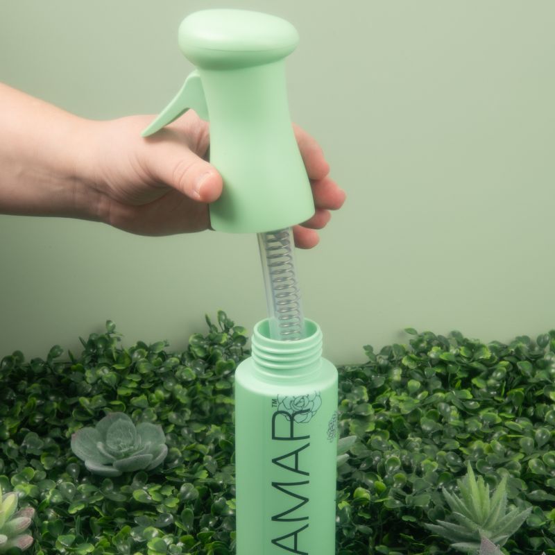 Showing the easy-to-refill twist top and interior hose of the Framar Plant Mom Myst Assist spray bottle