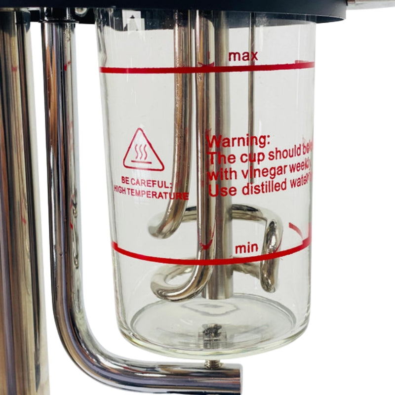 Close up of the heat resistant glass water canister and internal heating coil of the facial steamer