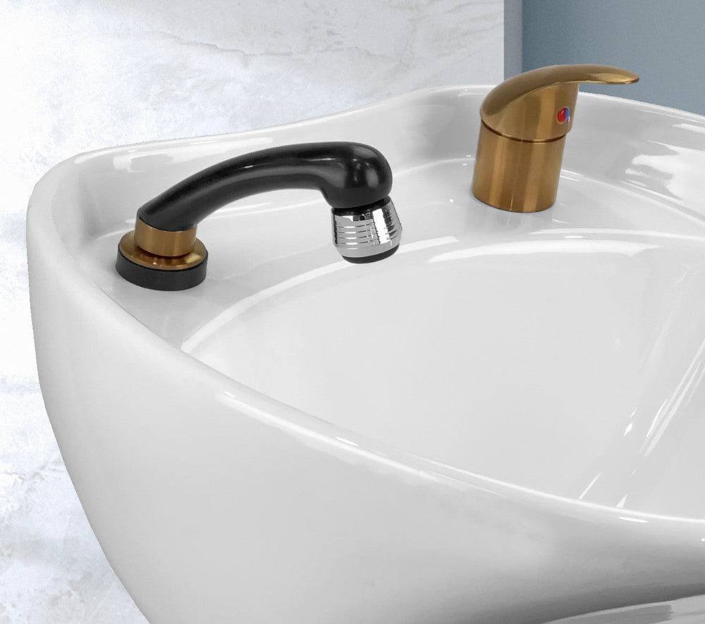 Close up of Joiken brushed gold mixer tap and black hand shower installed on a professional salon basin