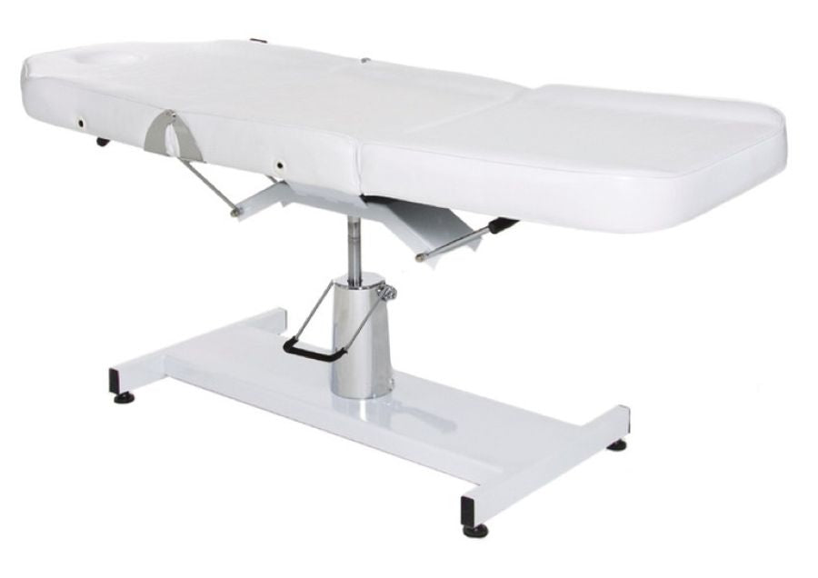 White Joiken hydraulic beauty bed shown in a fully flat treatment position