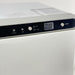 Detailed view of the hot and cold mode selection buttons on the Joiken towel unit