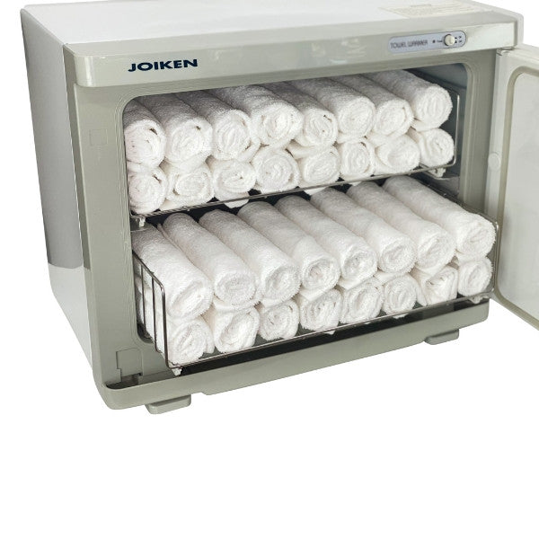Joiken white towel warmer filled with rolled towels showing compact space-saving design