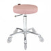 Pink upholstered salon stool with chrome base and clear rolling wheels for beauty clinics