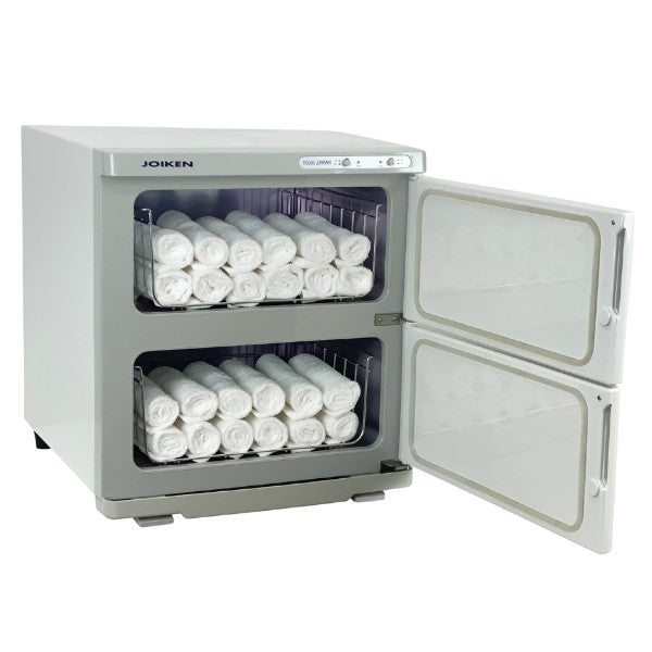 Professional white twin hot towel warmer filled with rolled towels for beauty treatments