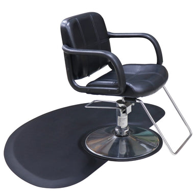 Karma black anti-fatigue hairdressing mat positioned under a professional salon chair with a round base