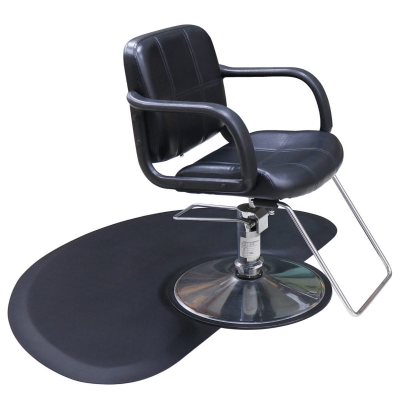 Karma black anti-fatigue hairdressing mat positioned under a professional salon chair with a round base