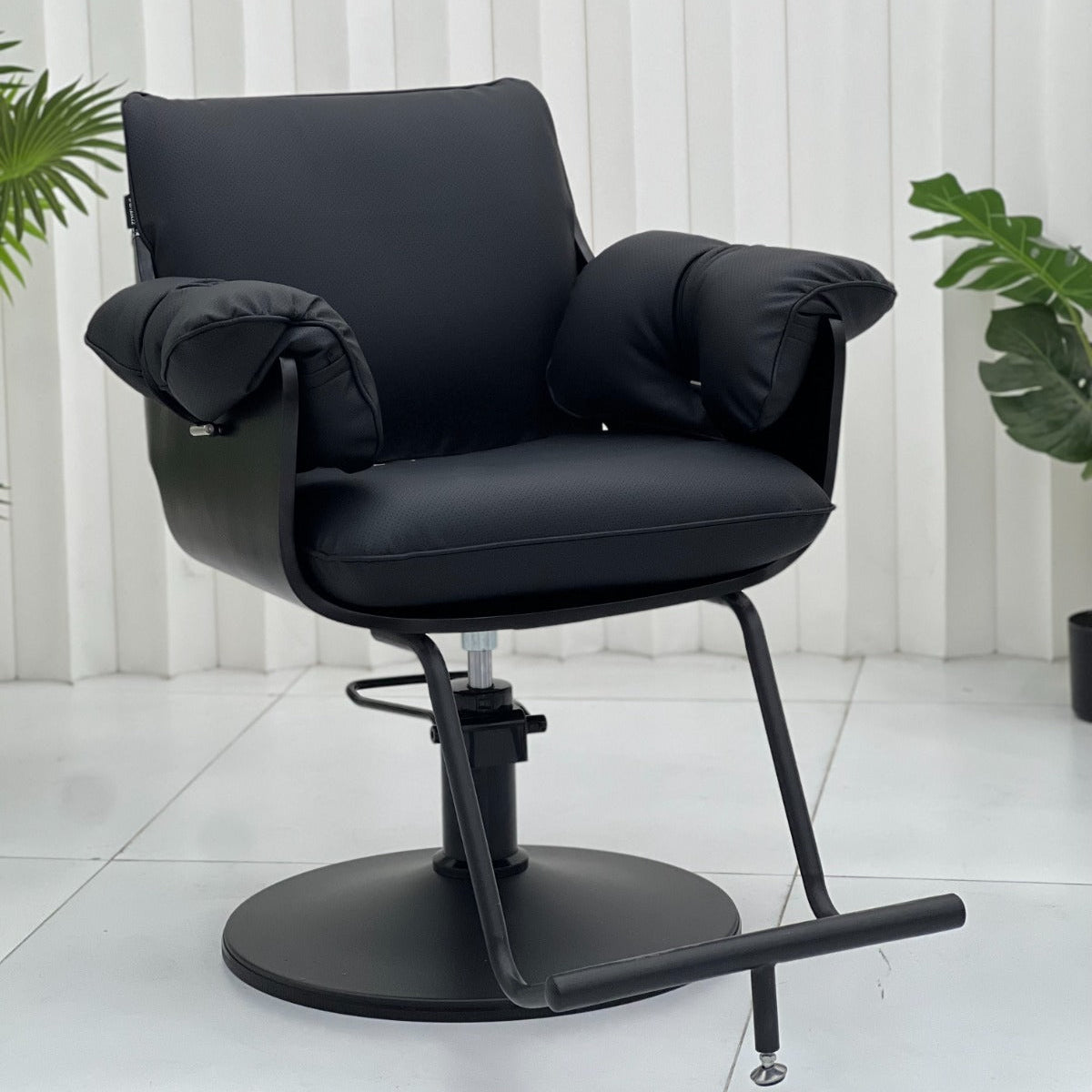 Angled view of the Karma Batemans Bay salon chair featuring a matte black hydraulic base