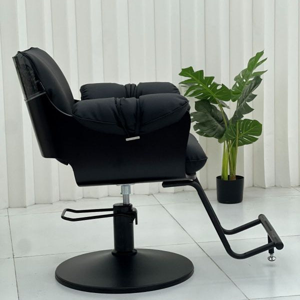 Side profile of the Karma Batemans Bay salon chair highlighting the cushioned armrests and hydraulic lever
