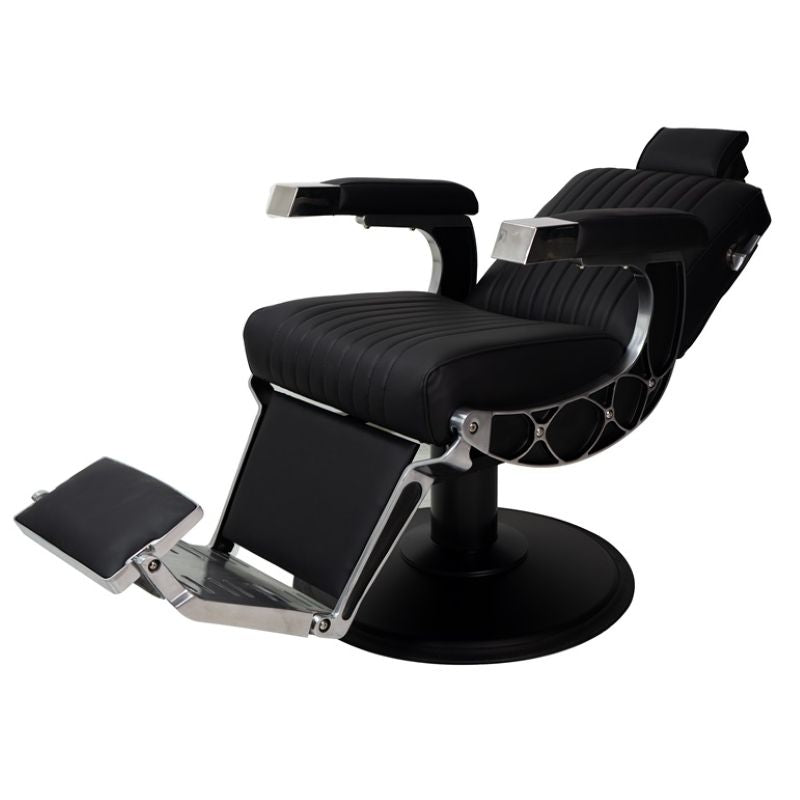 Angled view of the Karma Chandler black barber chair showing the footrest and hydraulic base