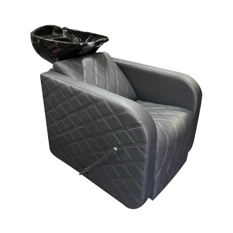Professional backwash station with a black tilting basin and quilted vinyl chair