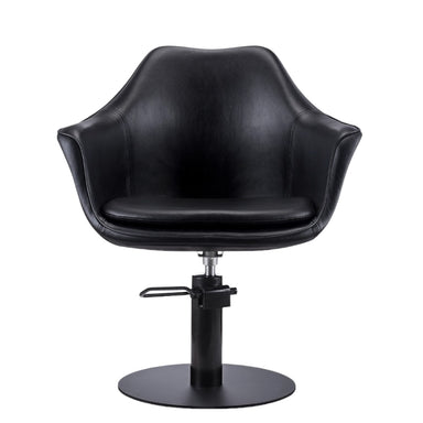 Front view of the Karma Cronulla salon chair in black vinyl with a modern sculptural design