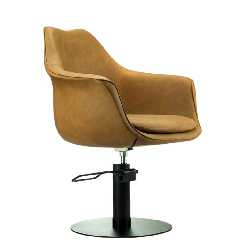 Side view of the tan Karma Cronulla styling chair showing the height adjustable hydraulic lever