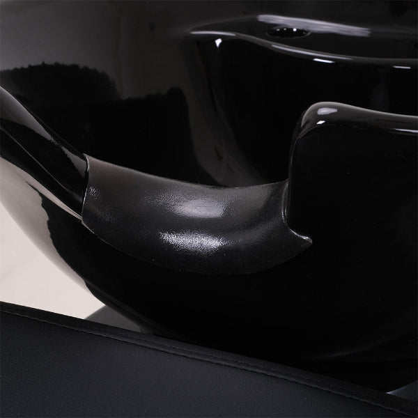 Close up interior view of the black ceramic shampoo basin and drainage system for salon use
