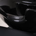 Close up interior view of the black ceramic shampoo basin and drainage system for salon use