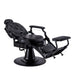 Fully reclined black barber chair showing extended footrest and headrest functionality