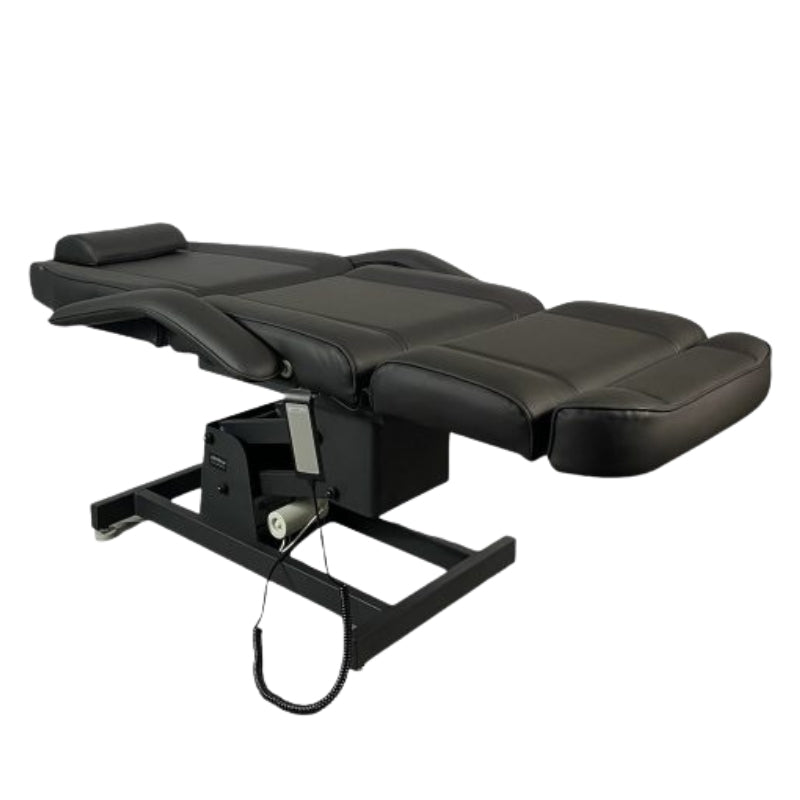Black Karma Hamilton electric beauty bed adjusted to a fully flat position for treatments
