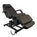 Black professional electric treatment bed with adjustable leg and back sections