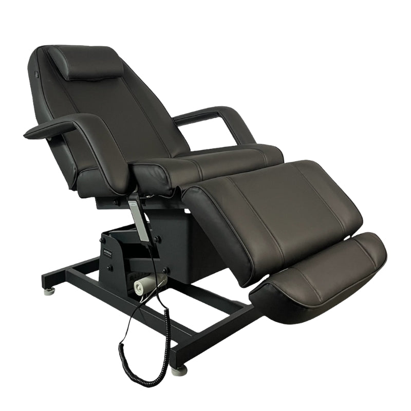 Black professional electric treatment bed with adjustable leg and back sections