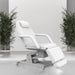Professional white electric beauty bed styled in a modern salon environment with plants