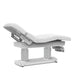 Professional electric beauty bed with the backrest inclined for client comfort during consultations