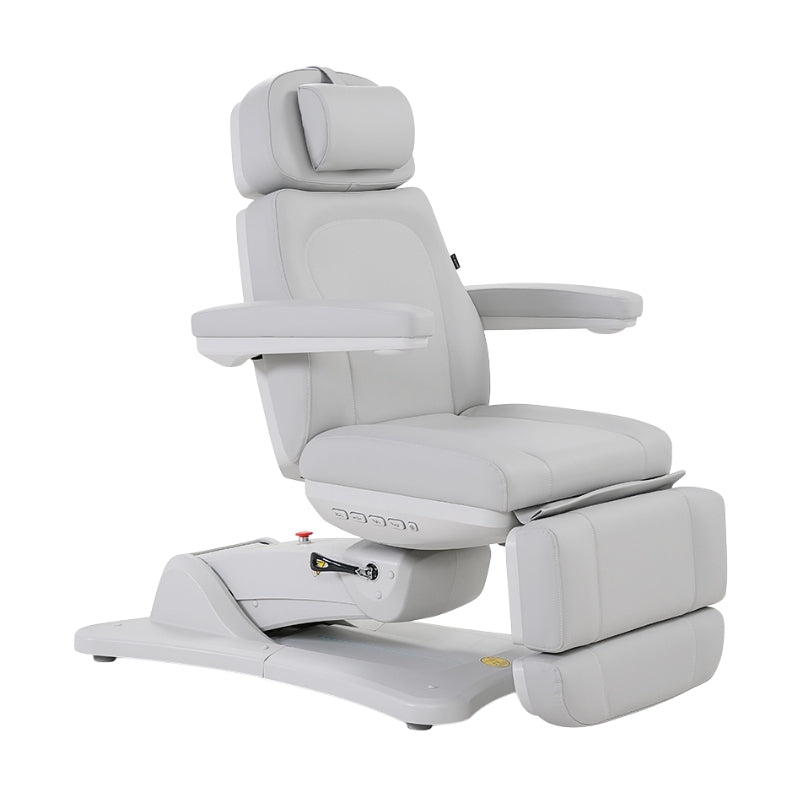 Karma Inglewood medical treatment table in white adjusted to an upright chair position with armrests