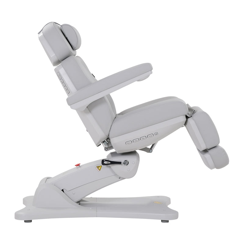 Side view of the Karma Inglewood treatment bed showing the electric tilt and leg rest adjustment