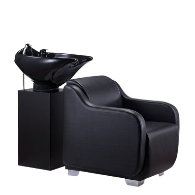 Side profile of the Karma Mortlake salon basin unit showing the black ergonomic chair and integrated shampoo sink